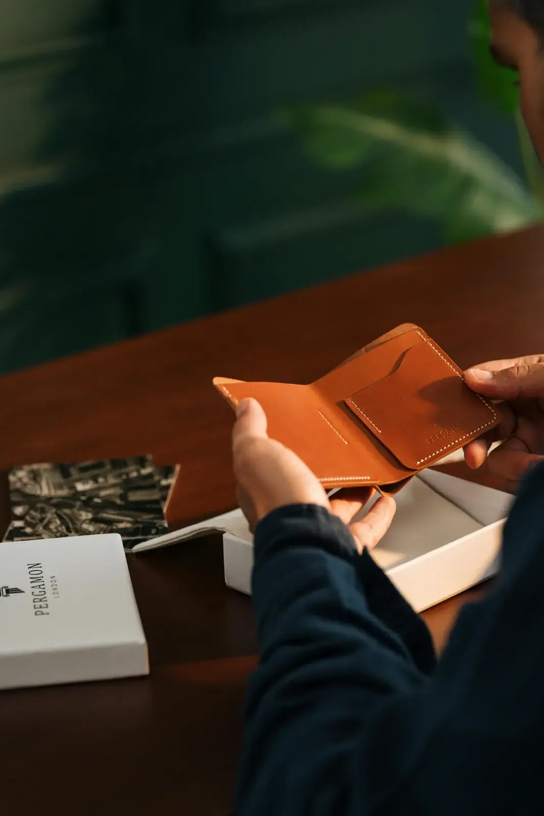 Premium leather wallet packaging box shown on a wooden table for product presentation